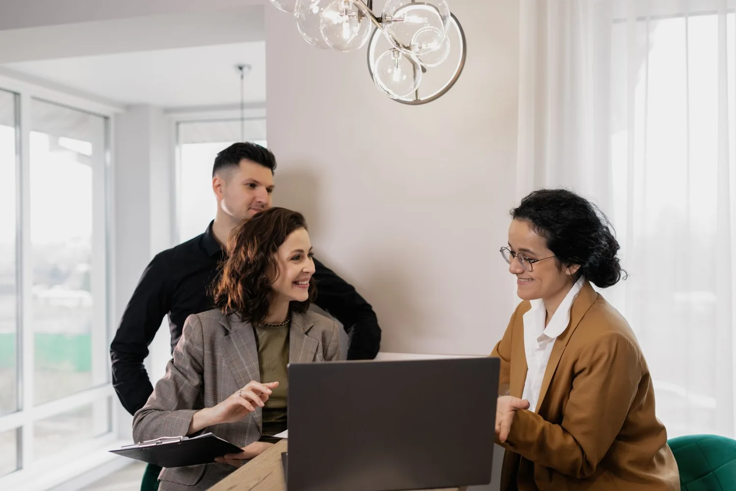 People discussing property with an estate agent in a bright office
